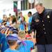 Ann Arbor Police Sgt. Tom Hickey high-fives Safety Town graduates as they file into graduation at Dicken Elementary School on Friday, July, 26, 2013. Melanie Maxwell | AnnArbor.com